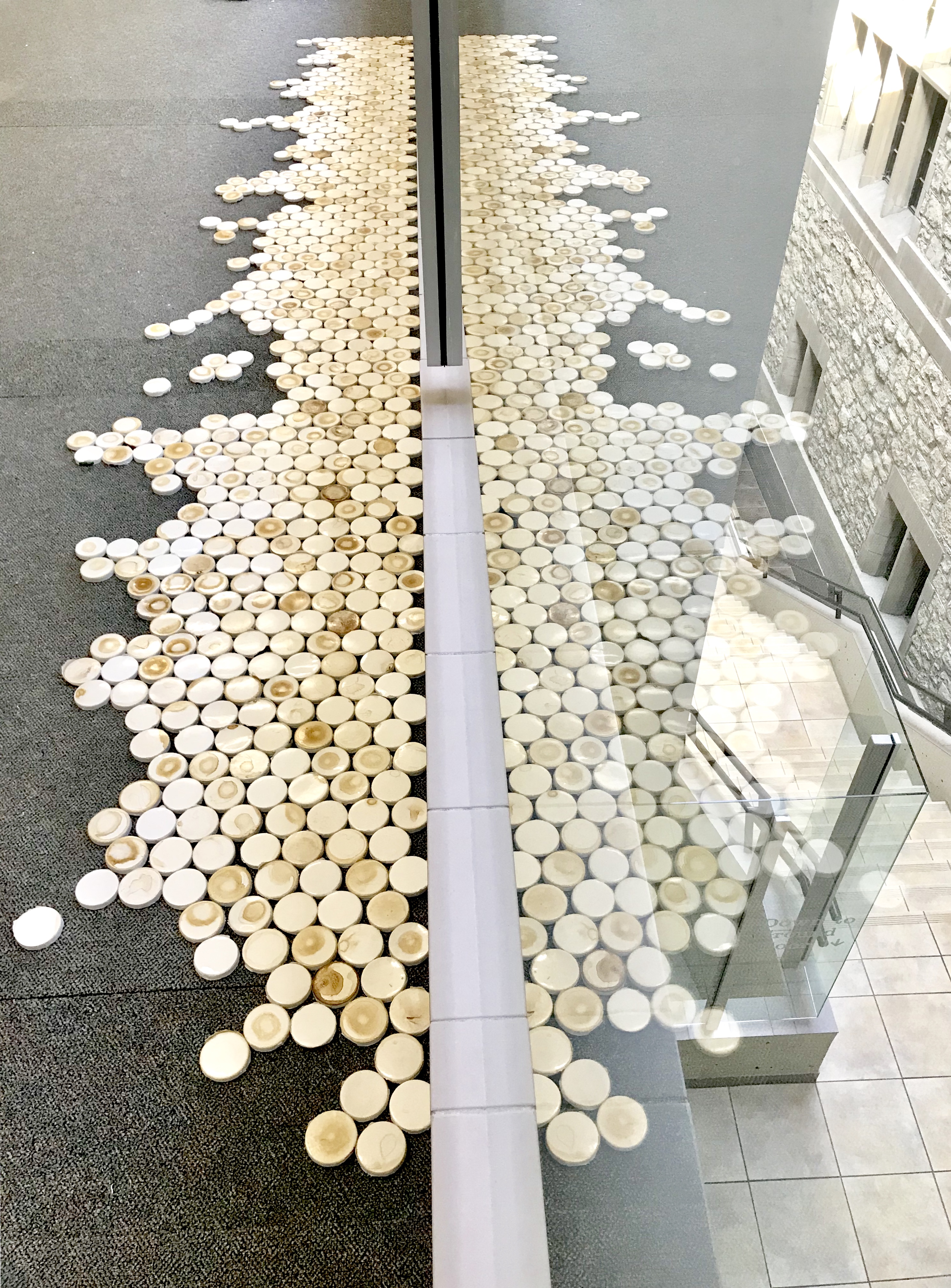 A mosaic of coffee cup lids created for ARTCycled 2018 by E Haffermehl